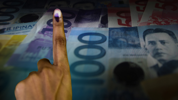 Hand with forefinger showing voting ink with background of peso bills for story: Lawmaker: Declare vote-buying a heinous crime