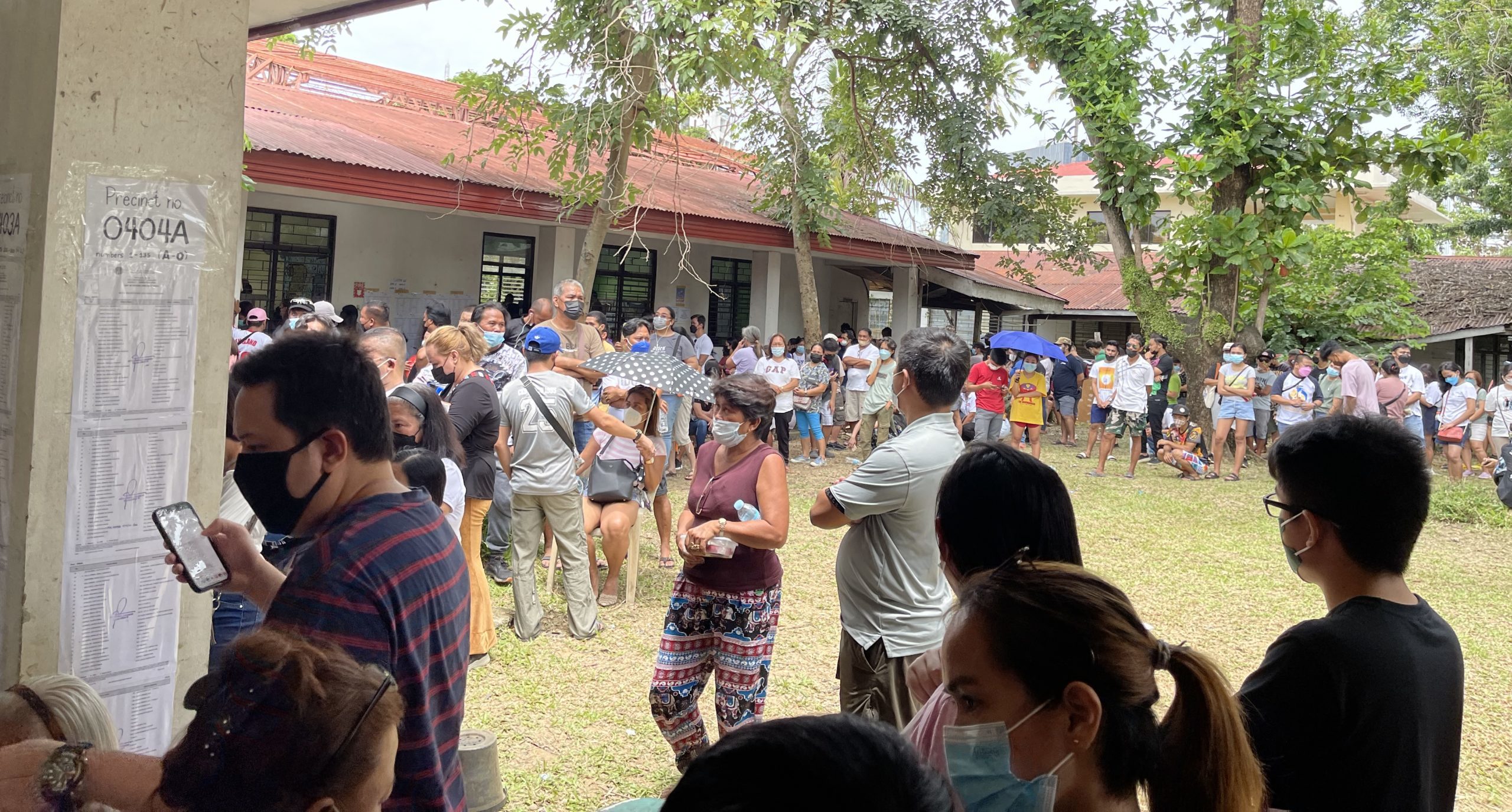 Voters patiently line up and wait for their turn at the University of the Philippines Cebu College in Barangay Lahug, Cebu City