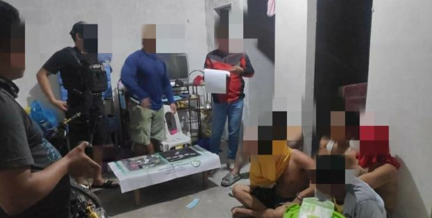 Philippine Drug Enforcement Agency-Region 3 agents inspect the evidence allegedly seized from the suspects during a buy-bust operation on May 19 in Lubao town, Pampanga province. (Photo courtesy of PDEA-3)