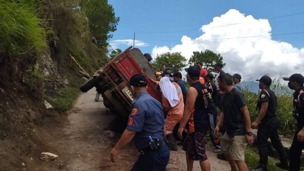 An Elf truck flipped onto its side after hitting a mountain slope in Bontoc town, Mountain Province on Tuesday (May 3) morning, injuring 13 people. (Contributed photo)