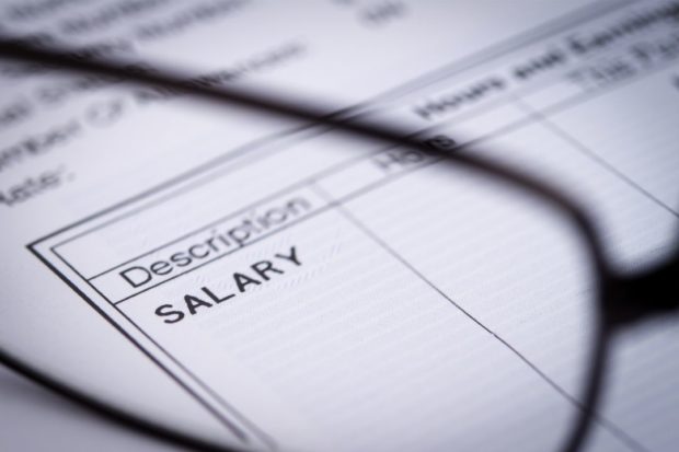 Stock photo showing paper with “SALARY” label. STORY: Employers, workers hit approved pay hike