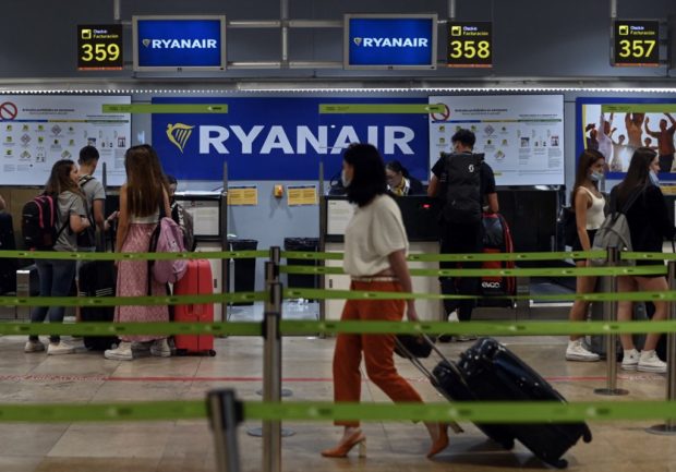 Passengers stand near the Ryanair check-in counters during a strike at Adolfo Suarez Madrid Barajas airport Madrid