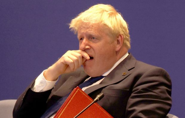 Britain's Prime Minister Boris Johnson yawns as he sits alongside other leaders during the Leaders' Retreat executive session on the sidelines of day six of the 2022 Commonwealth heads of Government meeting at the Intare Conference centre in Kigali