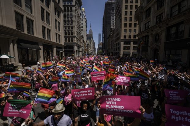 Participants march during the 2022 New York Pride Parade in New York City on June 26, 2022. (Photo by Ed JONES / AFP)