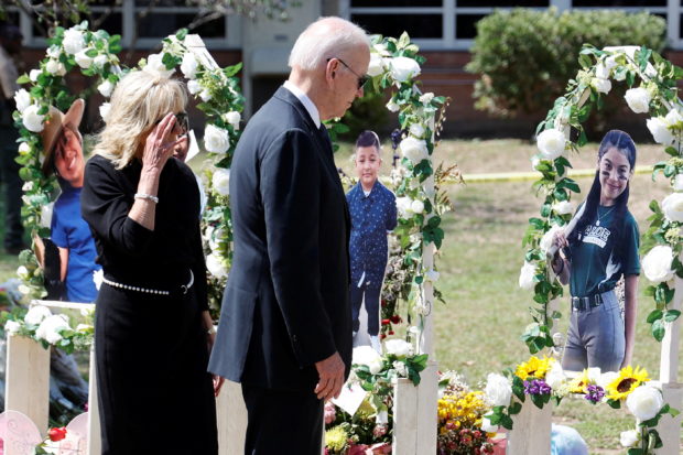 FILE PHOTO: U.S. President Joe Biden and first lady Jill Biden pay their respects at the Robb Elementary School memorial, where a gunman killed 19 children and two teachers in the deadliest U.S. school shooting in nearly a decade, in Uvalde, Texas, U.S. May 29, 2022. REUTERS/Jonathan Ernst