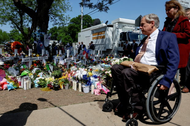 FILE PHOTO: Texas Governor Greg Abbott visit a memorial at Robb Elementary School, where a gunman killed 19 children and two teachers in the deadliest U.S. school shooting in nearly a decade, in Uvalde, Texas, U.S. May 29, 2022. REUTERS/Jonathan Ernst