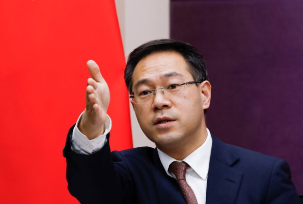 FILE PHOTO: Chinese Commerce Ministry spokesman Gao Feng gestures during a news conference in Beijing, China January 29, 2021. REUTERS/Tingshu Wang