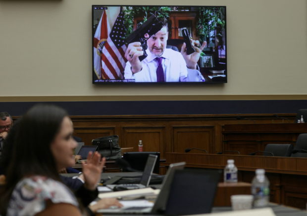 U.S. Representative Greg Steube (R-FL) holds up a handgun as he speaks via video link during the House Judiciary Committee hearing to markup the "Protecting Our Kids Act," legislation which includes an increase on the age limit on the purchase of certain firearms, modernising the prohibition on untraceable firearms, and the safe storage of firearms, on Capitol Hill in Washington, U.S., June 2, 2022. REUTERS/Evelyn Hockstein