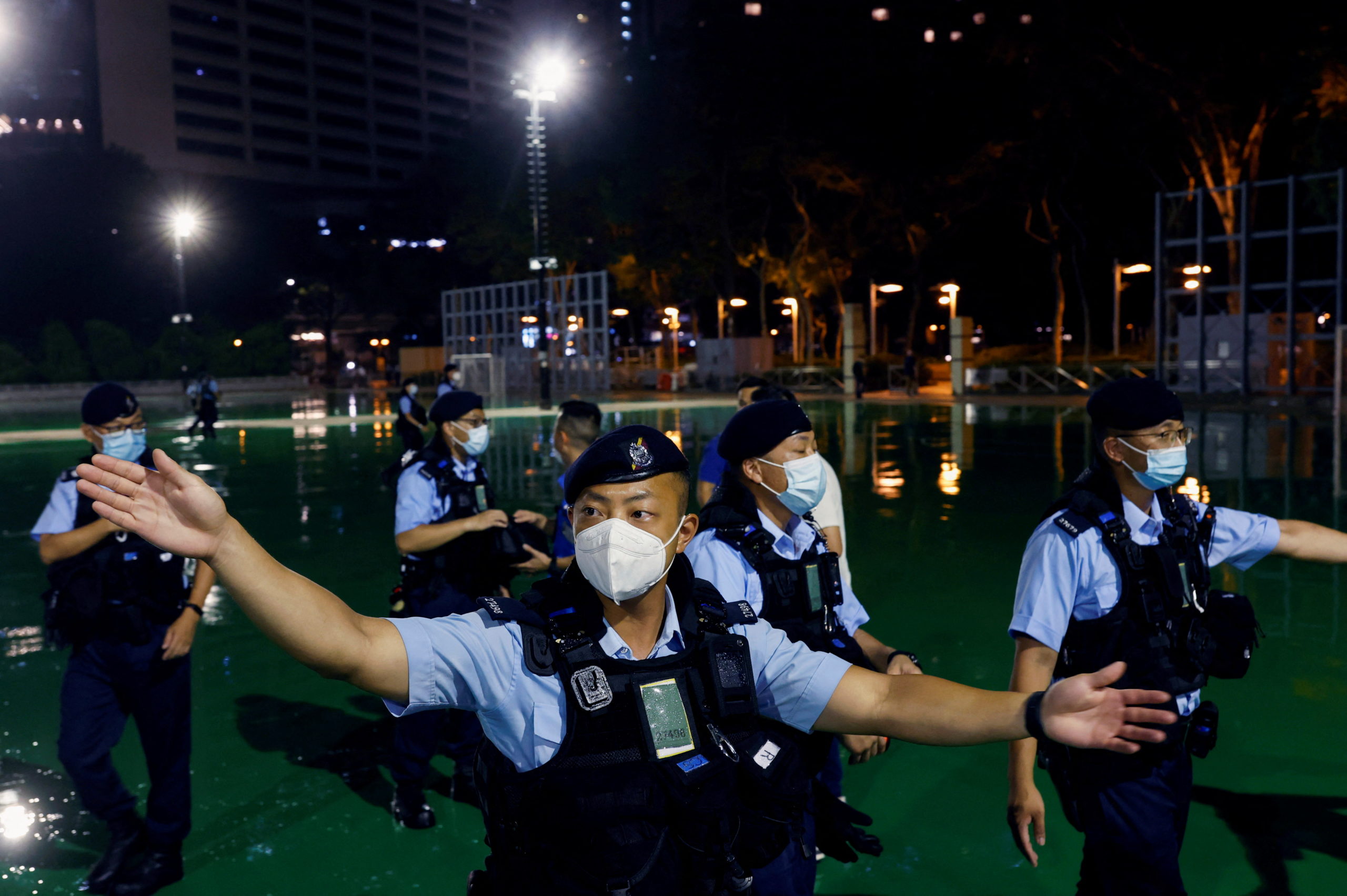 Police officers ask people to leave after announcing the closure of part of Victoria Park, where the candlelight vigil used to be held, a day a head of the 33rd anniversary of the crackdown on pro-democracy demonstrations at Beijing's Tiananmen Square, in Hong Kong, China, June 3, 2022. REUTERS/Tyrone Siu