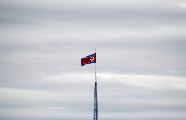 A North Korean flag flutters on top of a 160-metre tower in North Korea's propaganda village of Gijungdong, in this picture taken from the Tae Sung freedom village near the Military Demarcation Line (MDL), inside the demilitarised zone separating the two Koreas, in Paju, South Korea, April 24, 2018. REUTERS/Kim Hong-Ji/File Photo