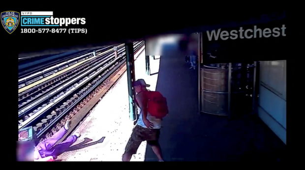 A man throws a woman onto train tracks in Bronx, New York City, New York, United States, June 5, 2022 in this still image from a social media video. Video recorded June 5, 2022. @NYPDTips via Twitter/via REUTERS