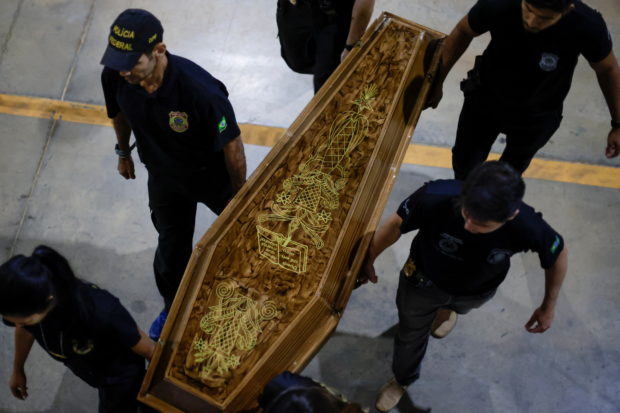 Federal Police officers carry a coffin containing human remains after a suspect confessed to killing British journalist Dom Phillips and Brazilian indigenous expert Bruno Pereira and led police to the location of remains, at the headquarters of the Federal Police, in Brasilia, Brazil, June 16, 2022. REUTERS/Ueslei Marcelino