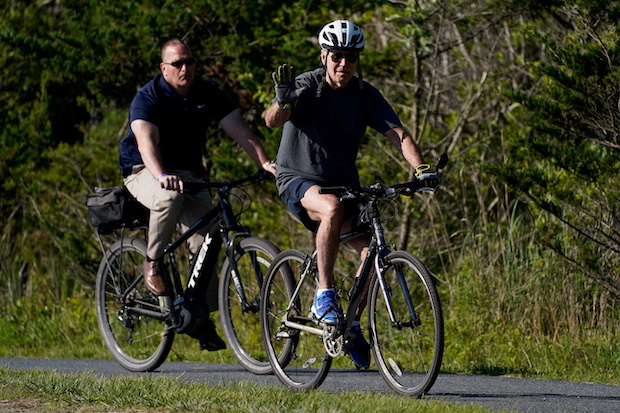 US President Joe Biden rides a bike in Rehoboth Beach, Delaware. STORY: Biden flubs bike dismount, falls, but uninjured