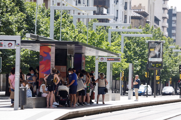 People waiting for a tram in Spain during a heatwave. STORY: Spain battles wildfires as it swelters in heatwave