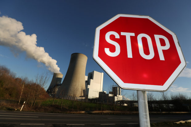 FILE PHOTO: A Stop sign stands in front of the Neurath lignite power plant of German utility RWE, west of Cologne, Germany, January 16, 2020. REUTERS/Wolfgang Rattay/File Photo