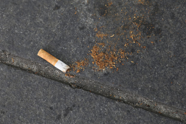 FILE PHOTO - A cigarette butt lies on a street in New York, U.S., May 10, 2017. REUTERS/Shannon Stapleton
