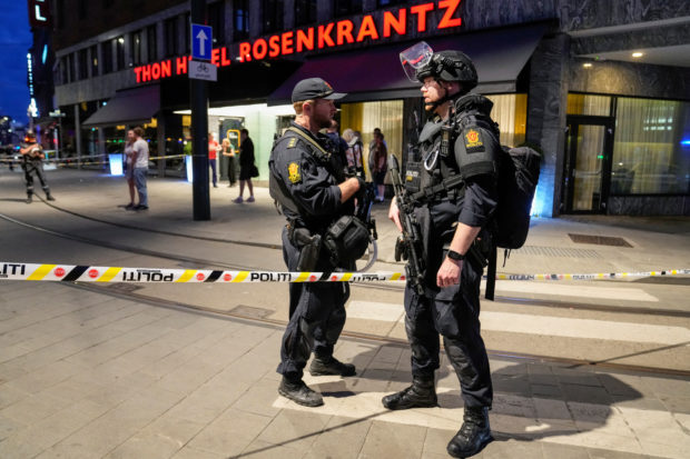 Security forces stand at the site where several people were injured during a shooting outside the London pub in central Oslo, Norway June 25, 2022. Javad Parsa/NTB/via REUTERS