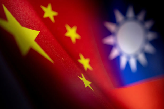 Chinese and Taiwanese printed flags are seen in this illustration taken, April 28, 2022. REUTERS/Dado Ruvic/Illustration