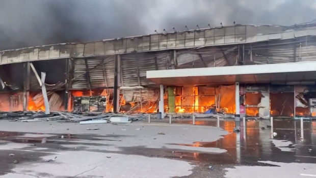 Smoke and fire raises from a shopping mall hit by a Russian missile strike, as Russia's attack on Ukraine continues, in Kremenchuk, in Poltava region, Ukraine June 27, 2022, in this screen grab taken from a video. Press service of the State Emergency Service of Ukraine/Handout via REUTERS