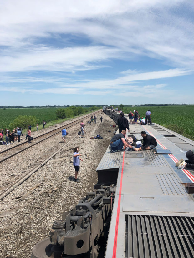 People exit from an Amtrak train that derailed after hitting a dump truck at an uncontrolled crossing, near Mendon, Missouri, U.S., June 27, 2022 in this picture obtained from social media. Dax McDonald/via REUTERS  THIS IMAGE HAS BEEN SUPPLIED BY A THIRD PARTY. MANDATORY CREDIT.
