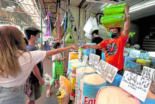 Rice store with customers in Marikina City Public Market. STORY: P20 per kilo rice possible as early as 2023 – DAR