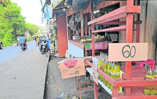 BARTER BENEFITS A roadside retailer in Bongao, Tawi-Tawi, sells gasoline at P60 a liter on June 13, way much cheaper than prices elsewhere in the country. The “imported” fuel is illegally brought in from Sandakan, Malaysia, via the barter trade that has existed in southern Philippines for centuries. —BONG SARMIENTO