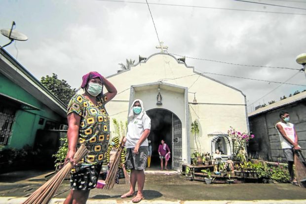 Residents of Juban, Sorsogon, start clearing a chapel compound of ash spewed by Mt. Bulusan on June 12. While evacuees have returned home, government volcanologists and disaster response teams are urging people to be alert and ready for another possible phreatic eruption at Bulusan. STORY: Agri losses from Bulusan blast reach P13.6M