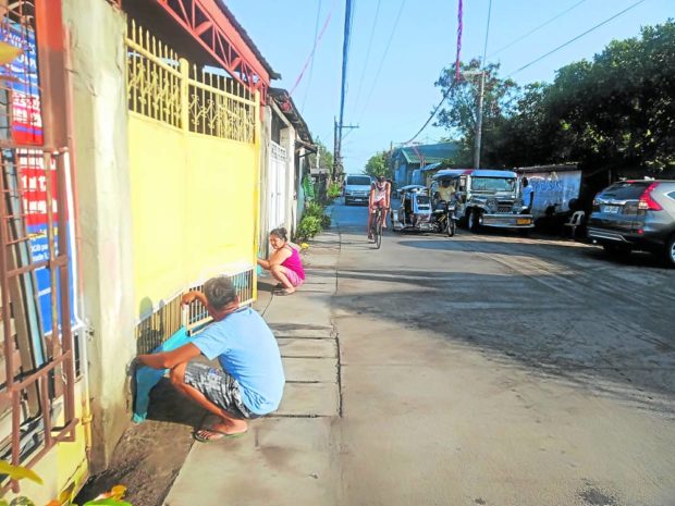 Residents in Obando, Bulacan, install net traps at their gates and front yards to prevent garbage from getting into their residences in case of another flash flood due to rising level of high tide, which is worsened by damaged stop gates and dike, in this photo taken on June 19. STORY: High tide damages dike, causes flash flood in Bulacan town