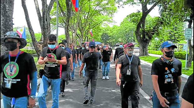 Employees of the state-owned Clark Development Corp. march out of their offices during lunch break on Friday to protest the reduction and removal of their allowances, benefits and incentives gained through collective bargaining agreements as the government implements a newcompensation system based on an executive order signed by President Duterte. STORY: Clark workers may lose allowances, benefits under new system