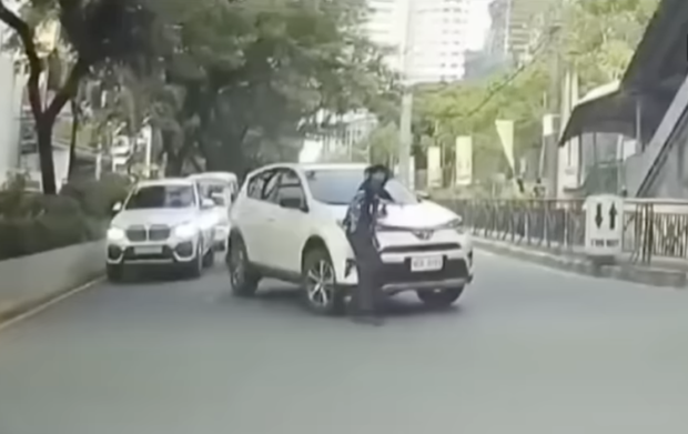 CAUGHT ON DASHCAM | The security guard is shown being run over by this motorist in this screengrab of the dashcam footage. (Video courtesy of MIKO ANGELO RAMOS)