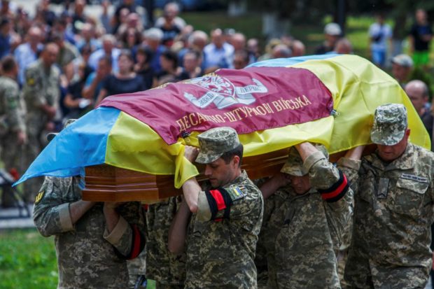 Ukrainian servicemen carry a coffin with a body of Ruslan Ferenci
