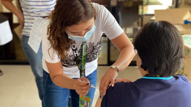 An employee of the Central Luzon Center for Health Development administers a booster shot to a person in a recent vaccination activity in the City of San Fernando, Pampanga. (Photo courtesy of DOH Health Central Luzon)