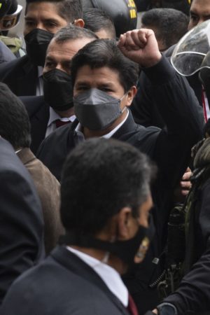 Peruvian President Pedro Castillo gestures upon arriving to the prosecutors headquarters in Lima on June 17, 2022, to clear accusations of leading a ring of influence peddling. 