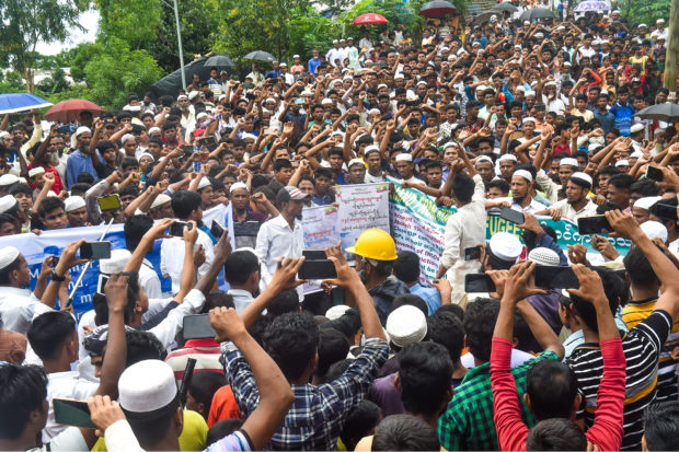 Rohingya refugees walk a "Go home campaign" rally demanding repatriation at Kutupalong Rohingya camp in Cox's Bazar on June 19, 2022. - Tens of thousands of Rohingya Muslims in Bangladesh's southeastern refugee camps on Sunday have demonstrated a "Go home" rally today ahead of the World Refugee Day. (Photo by Tanbir MIRAJ / AFP)