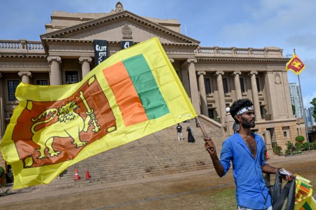 A man wears a headband with a slogan against interim Sri Lankan President Ranil Wickremesinghe