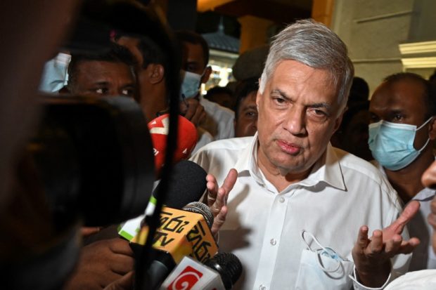 Sri Lanka's newly elected president Ranil Wickremesinghe addresses the media representatives during his visit at the Gangaramaya Buddhist temple in Colombo on July 20, 2022. - Sri Lanka's president-elect on July 20 vowed to take tough action against anyone resorting to what he called the undemocratic means that led to his predecessor's ouster. (Photo by Arun SANKAR / AFP)