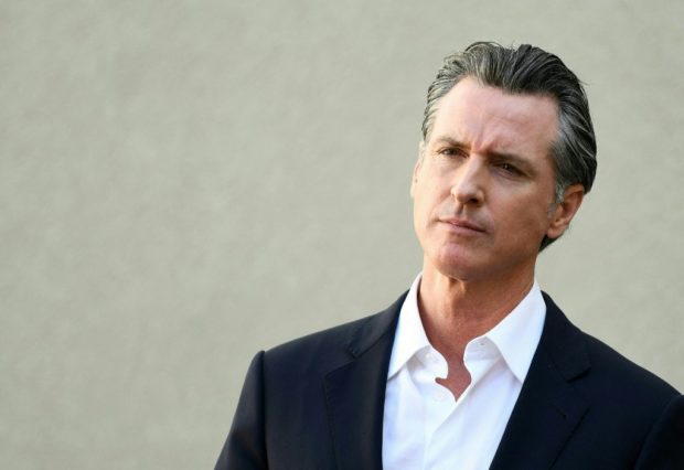 (FILES) In this file photo taken on November 10, 2021 California Governor Gavin Newsom (D-CA) listens to a question during a press conference about Covid-19 vaccinations and housing for homeless veterans in Los Angeles, California. - California's governor signed into law Friday new gun control legislation modeled on a controversial legal approach used in Texas to curb access to abortions. Last year, well before the US Supreme Court overturned the nationwide right to an abortion, the Republican-controlled state of Texas enacted a new law allowing individuals to sue anyone helping to terminate a pregnancy, if a fetal heartbeat could be detected. (Photo by Patrick T. FALLON / AFP)