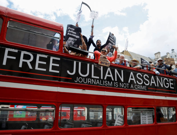 Protesters ride on a bus during a 'Free Assange' demonstration to mark WikiLeaks founder Julian Assange's birthday, in London, Britain, July 1, 2022. REUTERS/John Sibley