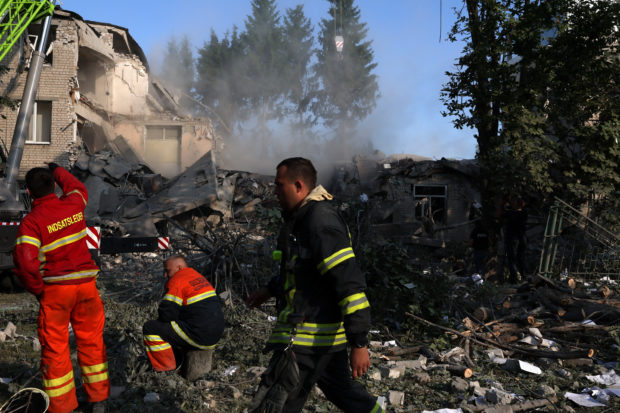 First responders work on the scene where a school was destroyed by early morning shelling as Russia's attack on Ukraine continues in Kharkiv, Ukraine, July 4, 2022. REUTERS/Leah Millis