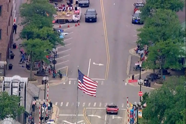 Police deploy after gunfire erupted at a Fourth of July parade route in the wealthy Chicago suburb of Highland Park, Illinois, U.S. July 4, 2022 in a still image from video. ABC affiliate WLS/ABC7 via REUTERS