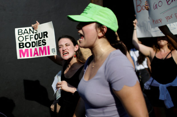 FILE PHOTO: An abortion rights protester holds a sign as she demonstrates after the U.S. Supreme Court ruled in the Dobbs v Women’s Health Organization abortion case, overturning the landmark Roe v Wade abortion decision in Miami, Florida, U.S. June 24, 2022. REUTERS/Marco Bello/File Photo