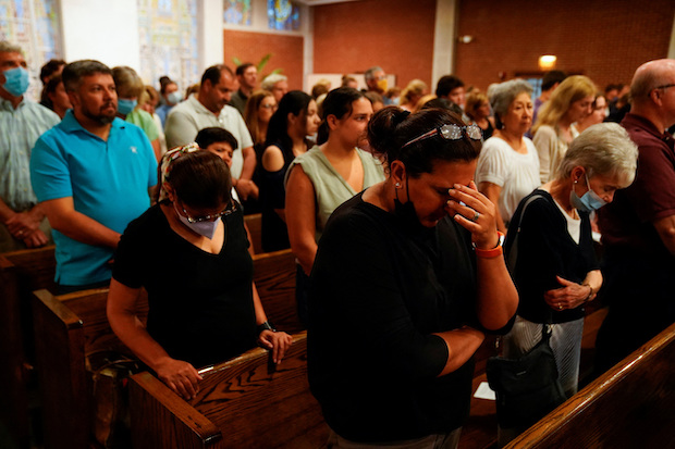 Community members gather for a prayer a day after Chicago shooting. STORY: Chicago suburb shooting suspect denied bail on 7 murder counts