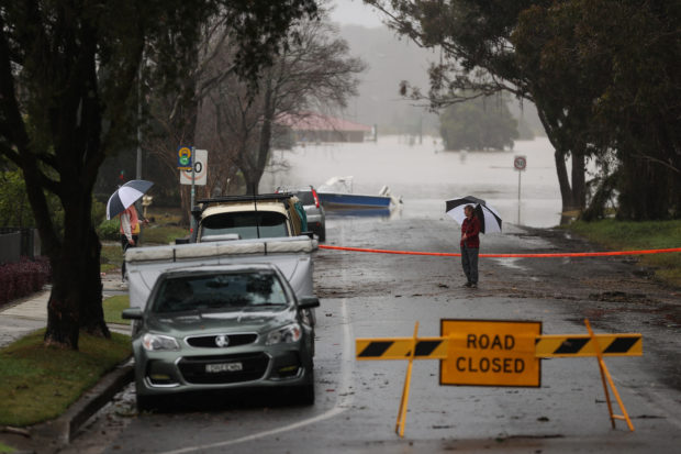 Floodwaters begin to recede after inundating a residential area, following heavy rains and severe flooding in the McGraths Hill suburb of Sydney, Australia, July 6, 2022. REUTERS/Loren Elliott