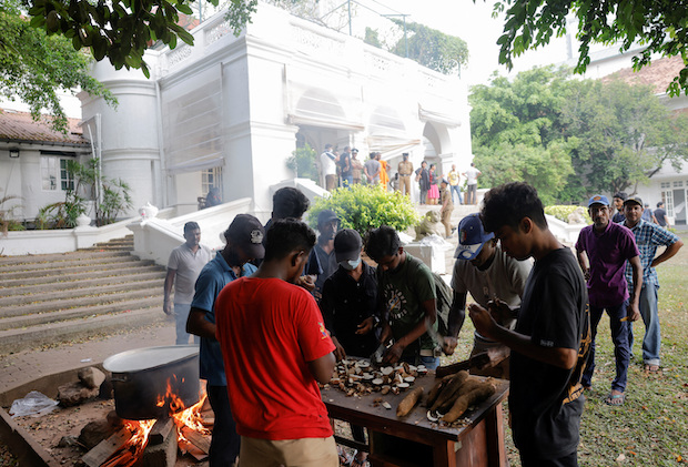 People cooking on the grounds of Sri Lankan PM’s residence. STORY: Protesters won’t stop until Sri Lanka leaders finally quit