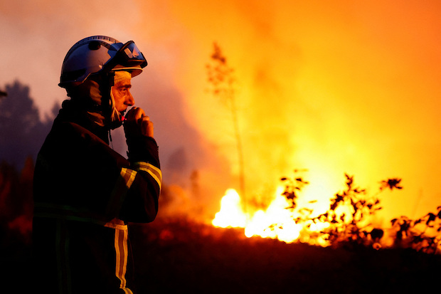 Firefighter at work in a wildfire in southwestern France. STORY: Southern Europe battles wildfires as heatwave spreads north