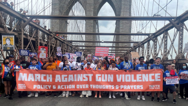 FILE PHOTO: People cross the Brooklyn Bridge as they attend "March for Our Lives" rally, one of a series of nationwide protests against gun violence, New York City, U.S., June 11, 2022. REUTERS/Eric Cox/File Photo