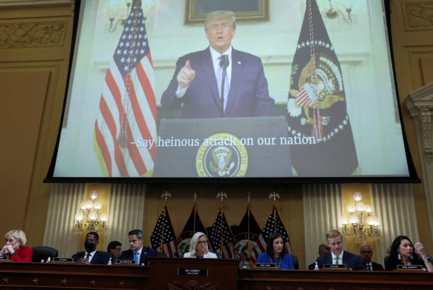 FILE PHOTO: A never before seen video of former U.S. President Donald Trump rehearsing a speech, where he refused to admit a day after the Jan. 6 assault on the U.S. Capitol that the 2020 election was over and that he had lost, is played on a screen during a public hearing of the U.S. House Select Committee to investigate the January 6 Attack on the U.S. Capitol, on Capitol Hill, in Washington, U.S., July 21, 2022. REUTERS/Evelyn Hockstein