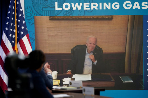 U.S. President Joe Biden, who has coronavirus disease (COVID-19) appears on a screen during a virtual meeting with his economic team at the White House in Washington, U.S., July 22, 2022. REUTERS/Elizabeth Frantz