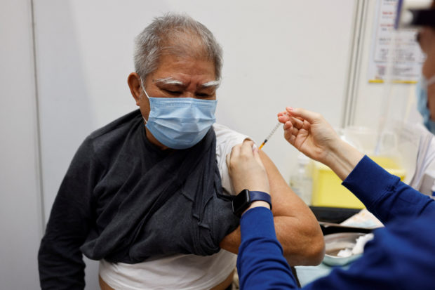 China says COVID-19 vaccines are safe as it reveals leaders have received shots