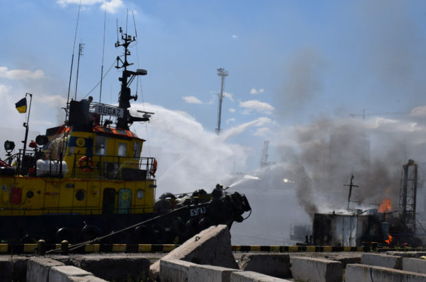 Firefighters work at a site of a Russian missile strike in a sea port of Odesa, as Russia's attack on Ukraine continues, Ukraine July 23, 2022. Press service of the Joint Forces of the South Defence/Handout via REUTERS
